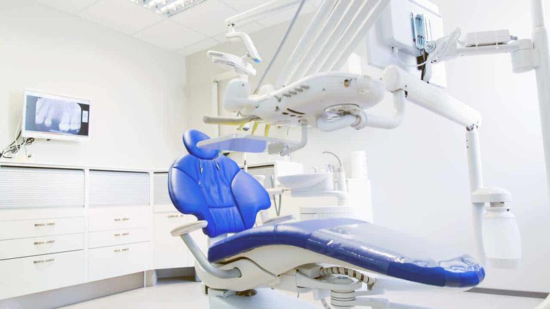 Blue dental chair with equipment in the medical office where you can have gum graft.