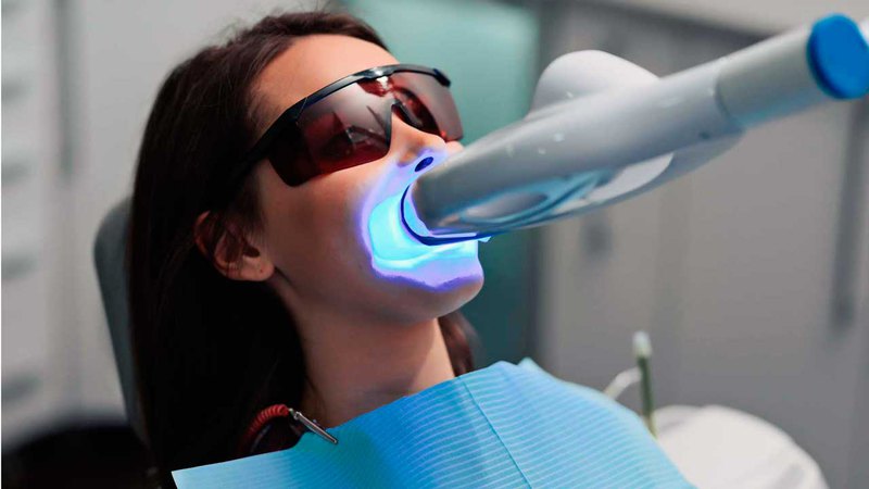 teeth whitening at dentist office with the use of special equipment